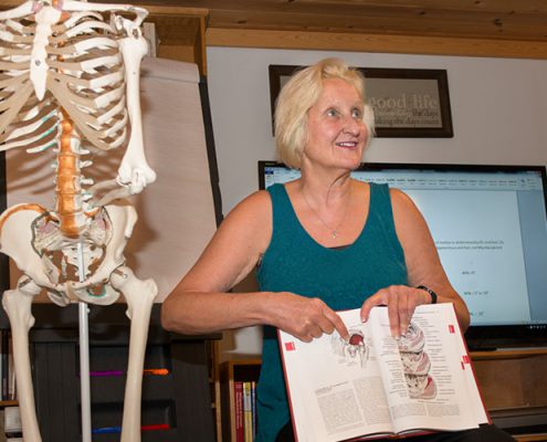 Donna Bajelis points to an anatomy illustration in a text book.